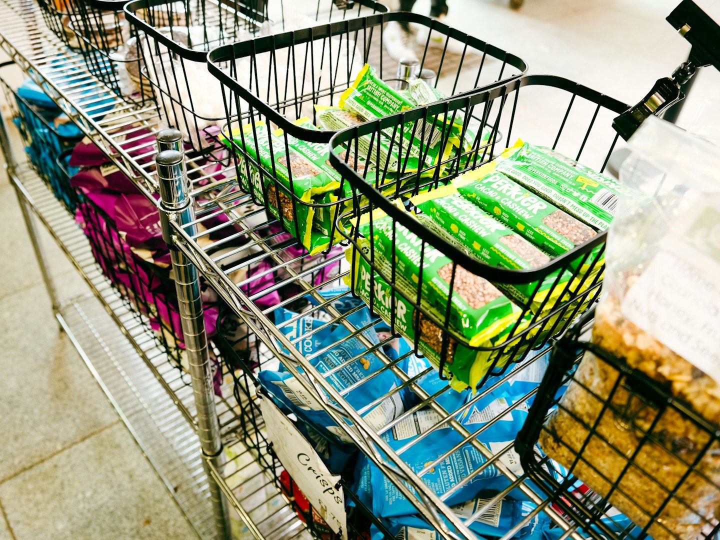 Packaged snack foods in retail display baskets.